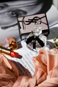 A stylish arrangement of perfume, lipstick, and accessories perfect for Valentine's Day gifting.