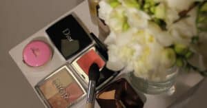 Stylish composition of cosmetics and white flowers on a table, perfect for beauty and fashion themes.