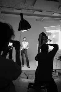 A professional studio setup capturing a model posing during a photoshoot.