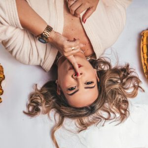 Elegant woman celebrating her 40th birthday with golden balloons in a stylish setting.